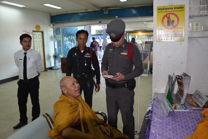Ni-orn Saenmuangchin, 51, sits Monday inside Udon Thani Police Station after he caused commotion at the provincial bus terminal.