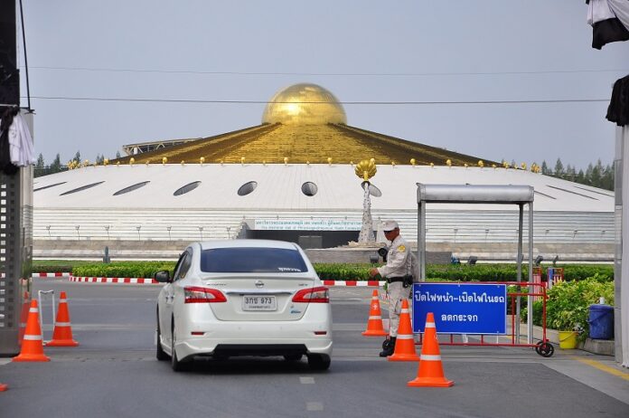 A vehicle waits to enter Wat Phra Dhammakaya on Wednesday in Pathum Thani province. Access is limited and media not allowed inside.