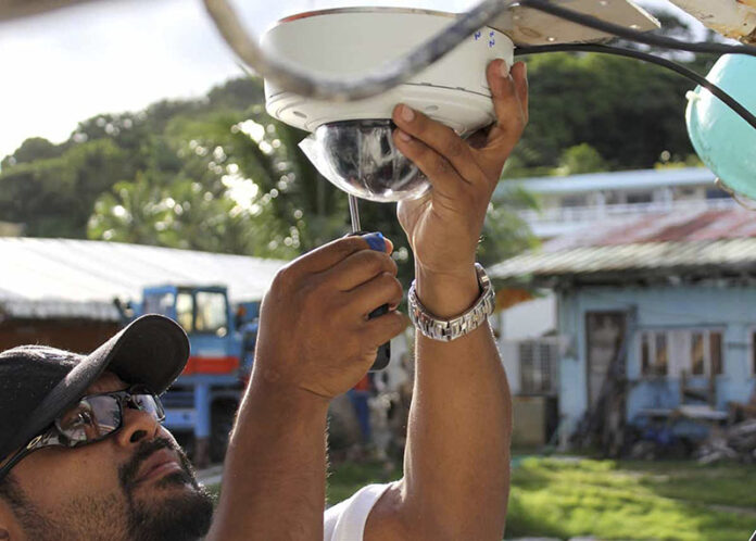 Kalie Luii, a compliance officer for the Division of Oceanic Fisheries Management in Palau, installs a Satlink camera faceplate with waterproof cover on a longline tuna boat on Sept. 29. Cameras are recording everything that comes over the rail and onto the deck of a few dozen tuna boats loaded with motion sensors and GPS systems in the western Pacific Ocean. Photo: Roll’em Productions / The Nature Conservancy / Associated Press