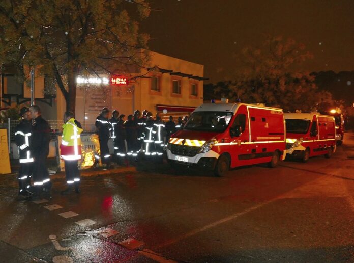 Firefighters and ambulances are seen in the village of Montferrier-sur-Lez, southern France on Friday. The French gendarmerie says a masked gunman has burst into a retirement home for monks in southern France and killed an elderly woman with a knife. The press service for the national military police couldn't immediately say whether the incident is linked to a terror act or not. Photo: Associated Press