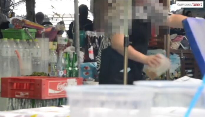 Still image from the video filmed by Chandrakasem Post shows the drink vendor throws ice left in used plastic cups back into the same icebox she uses to fill new drinks.
