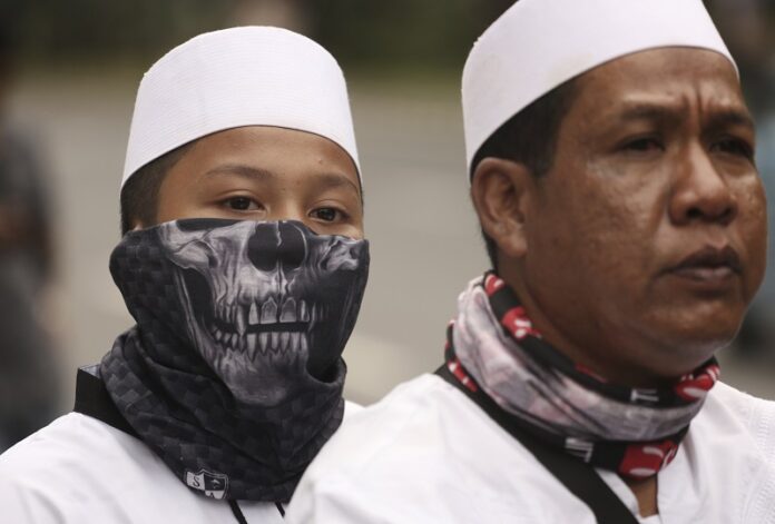 A Muslim protester wears a mask last October during a protest against Jakarta's ethic Chinese and Christian Governor Basuki Tjahaja Purnama, popularly known as 'Ahok', outside the City Hall in Jakarta, Indonesia. Photo: Achmad Ibrahim / Associated Press