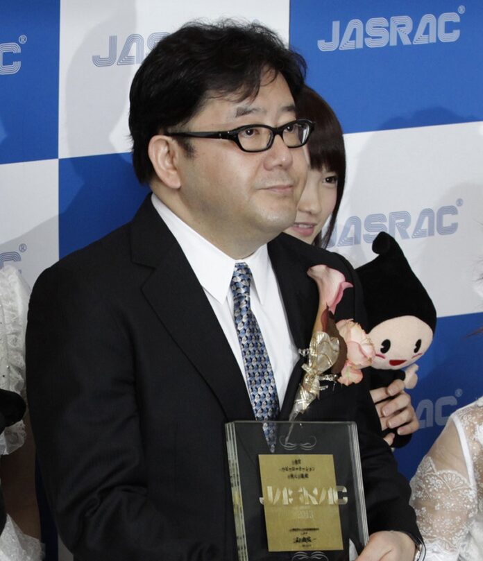 Yasushi Akimoto poses for photographers in 2013 during JASRAC (Japanese Society for Rights of Authors, Composers and Publishers) music award in Tokyo. Photo: Shizuo Kambayashi / Associated Press