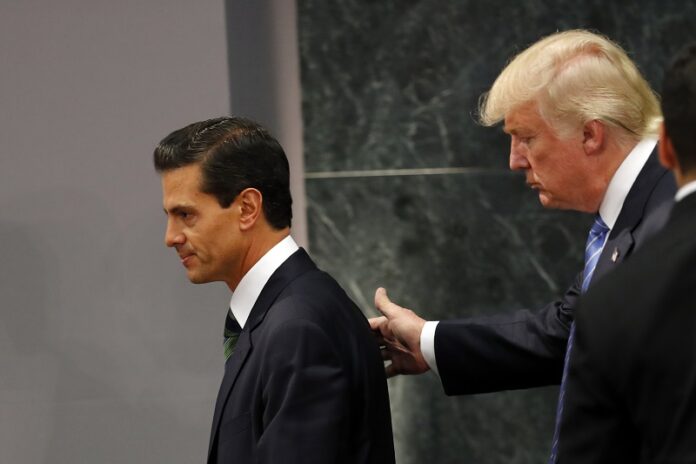 Republican presidential nominee Donald Trump walks with Mexico's President Enrique Pena Nieto in August at the end of their joint statement at Los Pinos, the presidential official residence, in Mexico City. Photo: Dario Lopez-Mills / Associated Press