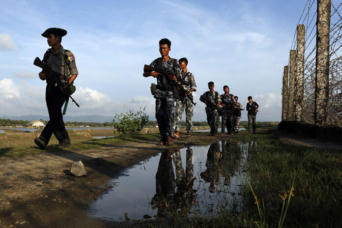 Myanmar police officers patrol the border fence between Myanmar and Bangladesh on Oct. 14 in Maungdaw, Rakhine State, Myanmar. Photo: Thein Zaw / Associated Press Myanmar police officers patrol the border fence between Myanmar and Bangladesh on Oct. 14, 2016, in Maungdaw, Rakhine State, Myanmar. Photo: Thein Zaw / Associated Press