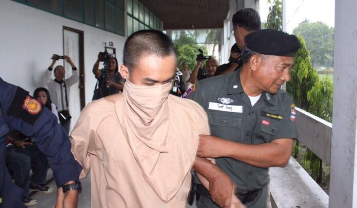 Alleged Phuket bomber Muhammad Muhi is led to the military court Tuesday in Nakhon Si Thammarat province.