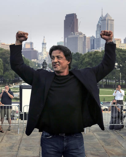 Actor Sylvester Stallone poses at the top of the steps of the Philadelphia Museum of Art before a statue of Rocky Balboa in 2006. (Photo: Rusty Kennedy / AP)