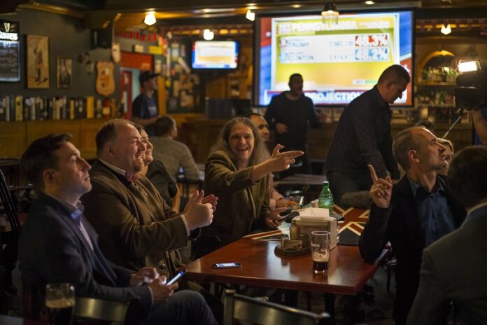 Russian political experts react as they watch a live telecast of the U.S. presidential election Wednesday in the Union Jack pub in Moscow, Russia. Photo: Alexander Zemlianichenko / Associated Press