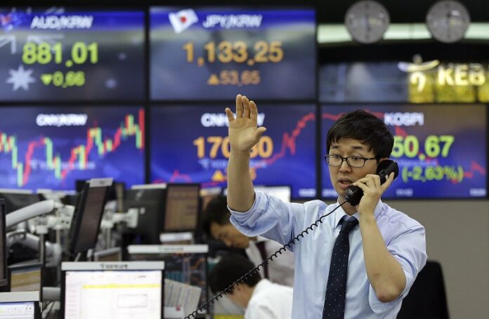A currency trader works at the foreign exchange dealing room of the KEB Hana Bank headquarters Wednesday in Seoul, South Korea. Photo: Ahn Young-joon / Associated Press