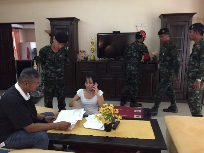 Officials search the home of German loan shark Wolfdieter Werner Mueller on Thursday afternoon in Nong Khai province.