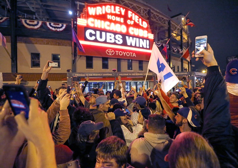 Chicago Cubs fans celebrate in front of Wrigley Field in Chicago on Wednesday after the Cubs defeated the Cleveland Indians 8-7 in Game 7 of the baseball World Series in Cleveland. Photo: Charles Rex Arbogast / AP
