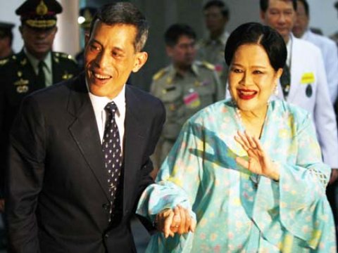 Her Majesty Queen Sirikit holds the arm of her son Crown Prince Vajiralongkorn as she waves to a crowd on March 12, 2009 outside Siriraj Hospital in Bangkok.