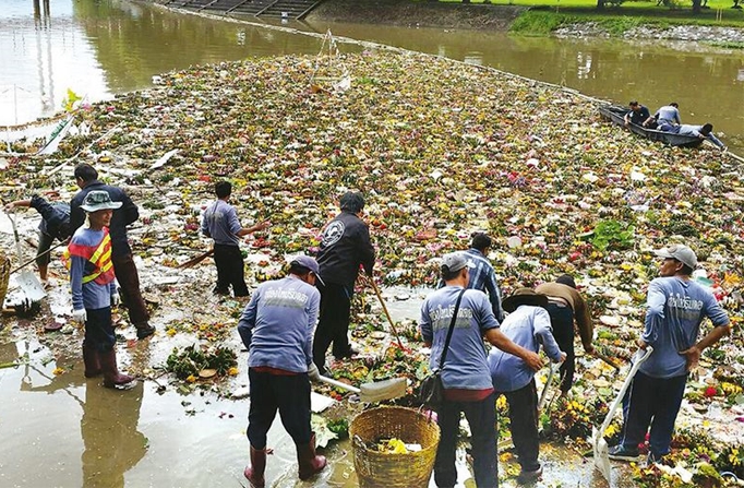 City workers clean krathongs from ponds and khlongs Tuesday morning in Bangkok.