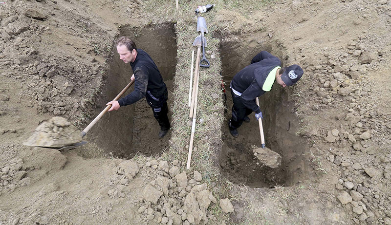 Grave diggers competes during the Grave Digging Championships on Thursday in Trencin, Slovakia. Photo: Ronald Zak / Associated Press
