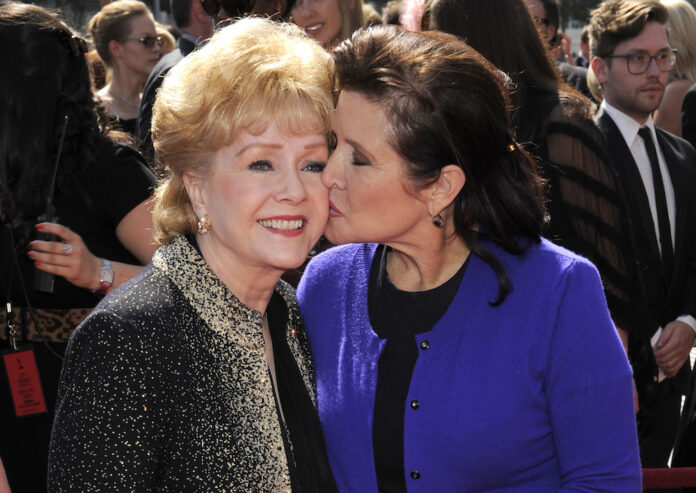 Debbie Reynolds, left, and Carrie Fisher arrive at the Primetime Creative Arts Emmy Awards in Los Angeles Sept. 10, 2011. Photo: Chris Pizzello / AP.