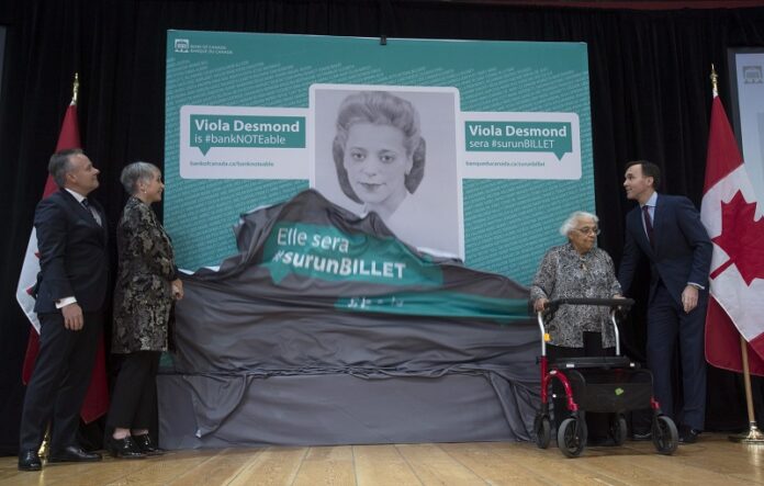 Bank of Canada Governor Stephen Poloz, left, Minister of Status of Women Patricia Hajdu, Minister of Finance Bill Morneau, right, and Wanda Robson unveil an image of Viola Desmond who will be featured on the new Canadian ten dollar bill during a ceremony Thursday in Gatineau, Quebec, Canada. Photo: Adrian Wyld / Associated Press