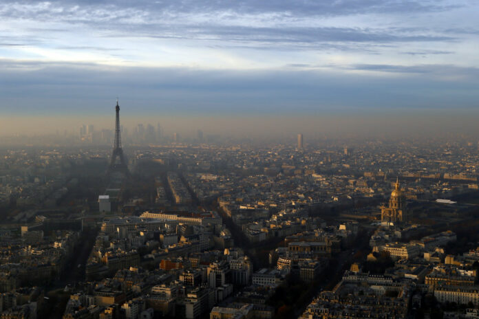 On Dec. 7, Paris' Police authority is again cracking down on the city's rocketing air pollution with a 24-hour traffic-regulating scheme that aims to halve the day's emissions from road vehicles. Photo: Francois Mori / AP.
