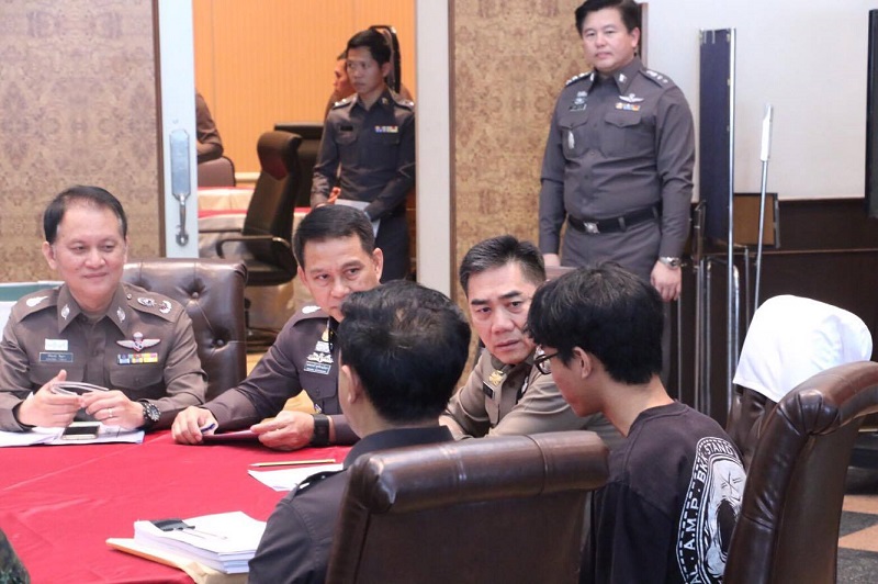 National Police Chief Gen. Chakthip Chaijinda speaks with Natdanai Kongdi, who has been accused of hacking a police database.