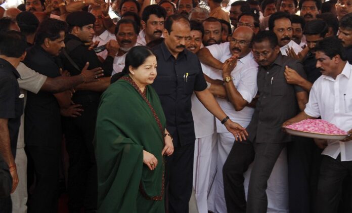 Leader of the AIADMK party Jayaram Jayalalithaa arrives to offer a floral garland to a portrait of party founder M.G. Ramamchadran in May in Chennai, India. Photo: Arun Sankar K / Associated Press