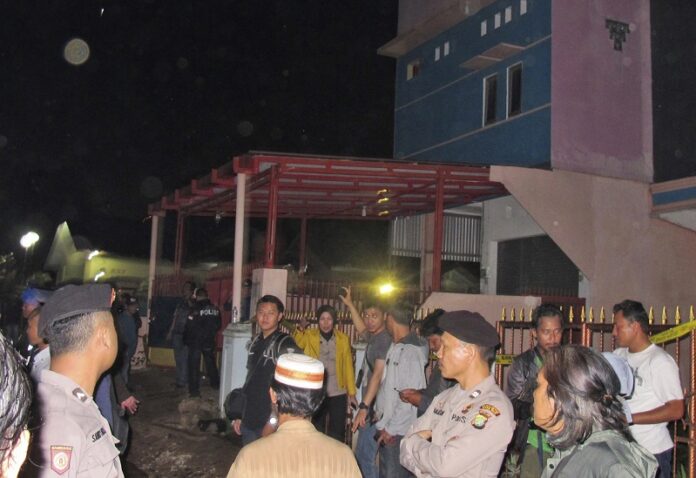 Officers stand guard around a house after it was raided by police Dec. 10 in Bekasi, West Java, Indonesia. Photo: Associated Press