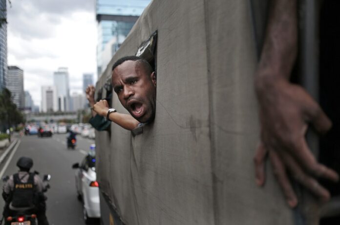 A West Papuan protester shouts slogans as he and others are taken away on a police truck during a rally calling for the remote region's independence, Dec. 1 in Jakarta, Indonesia. Photo: Dita Alangkara / Associated Press