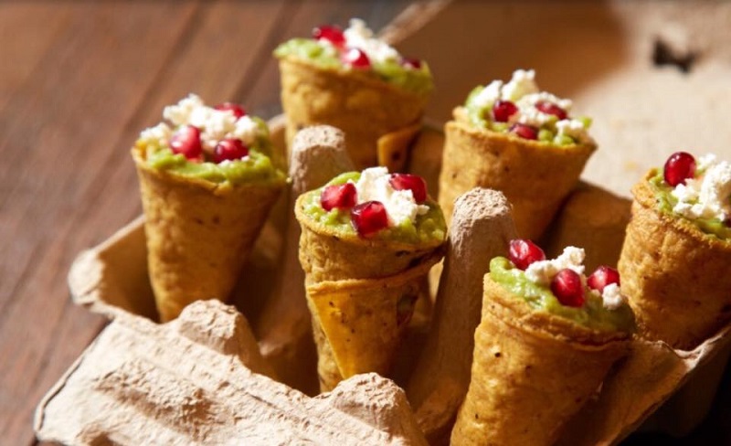 Corn tortilla cones stuffed with guacamole, topped with cheese and pomegranate seeds. Photo: Ceresia Coffee Roasters / Facebook
