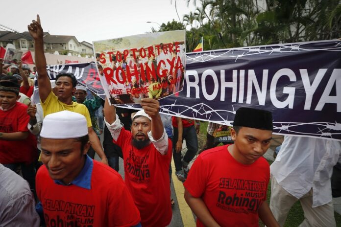 Ethnic Rohingya along with a Malaysian Islamic group protest after Friday prayers outside the Myanmar Embassy in Kuala Lumpur, Malaysia. Photo: Vincent Thian / Associated Press