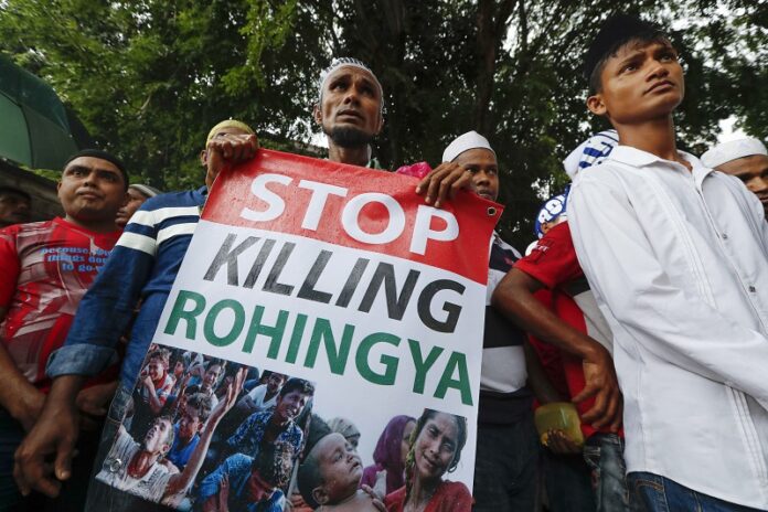 An ethnic Rohingya holds a banner during protest after Friday prayers outside the Myanmar Embassy in 2016 in Kuala Lumpur, Malaysia. Photo: Vincent Thian / Associated Press