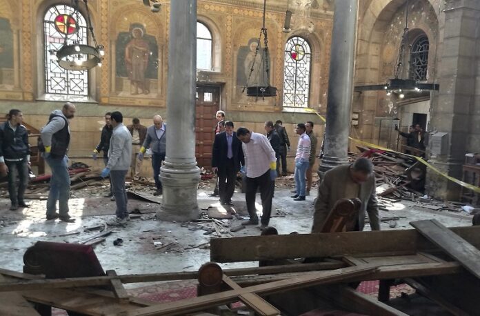 Egyptian security forces examine the scene inside St. Mark Cathedral in central Cairo, following a bombing on Sunday. Photo: Omar El-Hady / Associated Press
