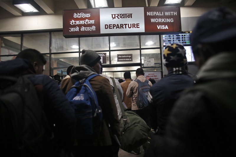 Nepali workers stand in queues at the departure gate for migrant workers in November at Tribhuwan International Airport in Kathmandu, Nepal. Photo: Niranjan Shrestha / Associated Press
