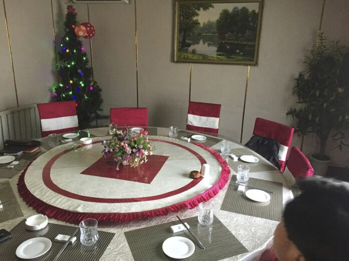 A Christmas tree stands in the corner of a private room Dec. 12 at a restaurant in Pyongyang, North Korea. Photo: Eric Talmadge / Associated Press