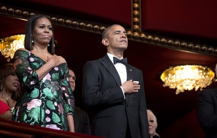 President Barack Obama and first lady Michelle Obama, put their hand over their heart Sunday as the national anthem is sang during the Kennedy Center Honors Gala at the Kennedy Center in Washington. Photo: Manuel Balce Ceneta / Associated Press