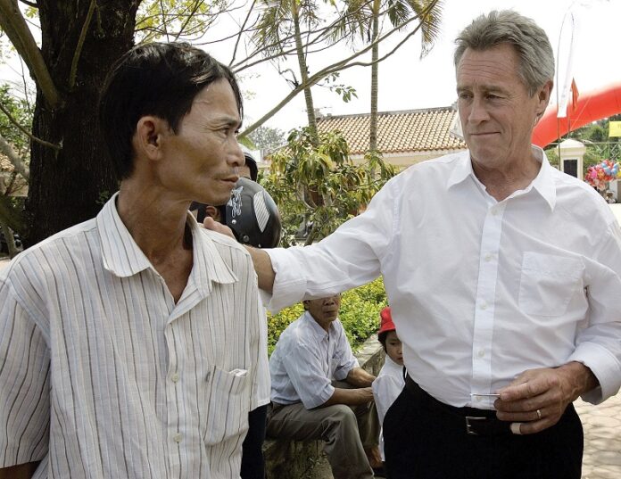 My Lai Massacre survivor Do Ba, 48, left, stands with former U.S. Army officer Lawrence Colburn, 58, right, in 2008 who rescued him during the March 16, 1968 My Lai massacre, during the 40th anniversary of the incident in My Lai, Quang Ngai Province, Vietnam. Photo: Chitose Suzuki / Associated Press