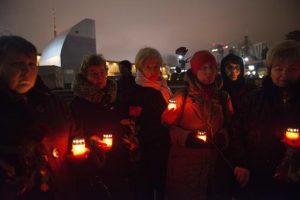 People light candles in memory of victims of the crashed plane in the center of Sochi, Russia, Sunday.