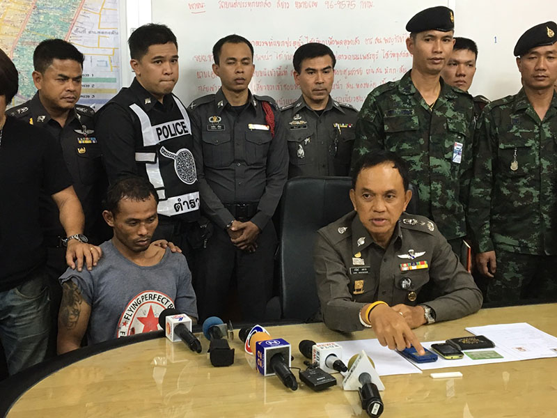 Bangkok police chief Sanit Mahathavorn, seated at right next to the unidentified suspect, speaks to reporters Wednesday afternoon in Bangkok.