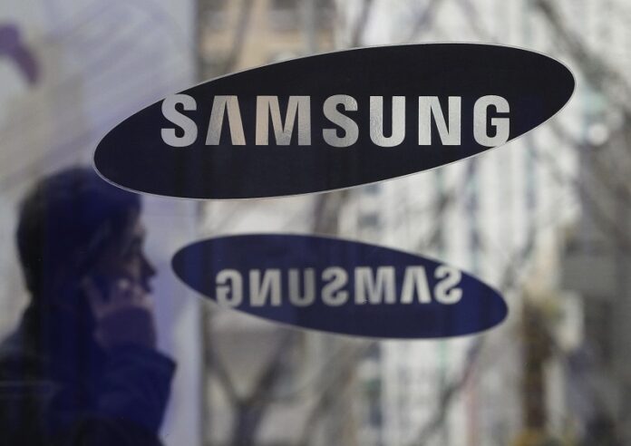 A man passes by the Samsung Electronics Co. logos at its headquarters in 2013 in Seoul, South Korea. Photo: Ahn Young-joon / Associated Press