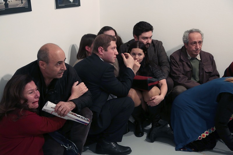 People crouch in a corner after Andrei Karlov, the Russian Ambassador to Turkey, was shot at a photo gallery in Ankara, Turkey, Monday, Dec. 19, 2016. Karlov, 62, was several minutes into a speech at an embassy-sponsored photo exhibition when a man fired a gun at him. Karlov was rushed to a hospital after the attack and later died from his gunshot wounds. Photo: Burhan Ozbilici / Associated Press