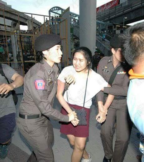 Chanoknan Ruamsap being removed from a protest and taken into custody.