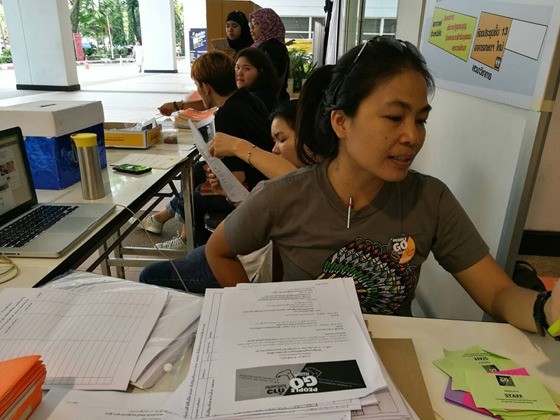 Siriphorn Chaiphet of the Thai Volunteer Service Foundation registers visitors to the People Go Network Forum on Saturday at Chulalongkorn University in Bangkok.