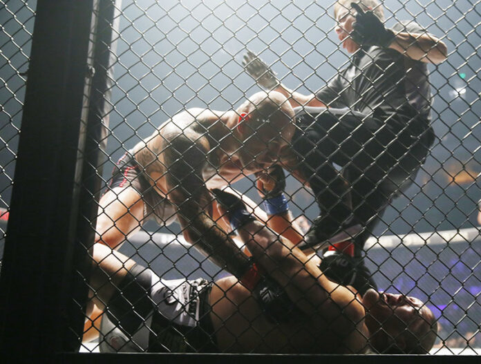 The referee tries to stop the fight as the Philippines' Brandon Vera pins down Japanese Hideki Sekine in their MMA (Mixed Martial Arts) One Heavyweight World Championship title fight on Friday at the Mall of Asia Arena in suburban Pasay city south of Manila, Philippines. Photo: Bullit Marquez / Associated Press