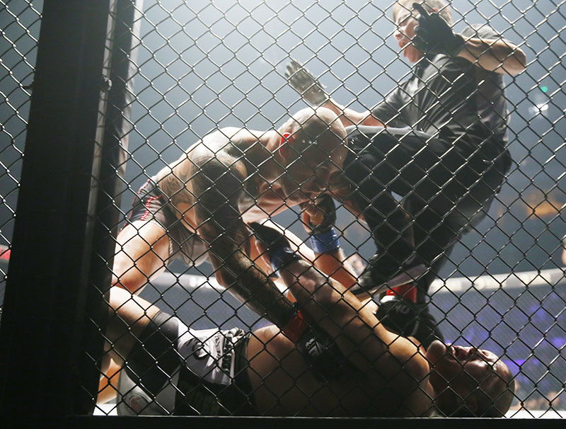 The referee tries to stop the fight as the Philippines' Brandon Vera pins down Japanese Hideki Sekine in their MMA (Mixed Martial Arts) One Heavyweight World Championship title fight on Friday at the Mall of Asia Arena in suburban Pasay city south of Manila, Philippines. Photo: Bullit Marquez / Associated Press