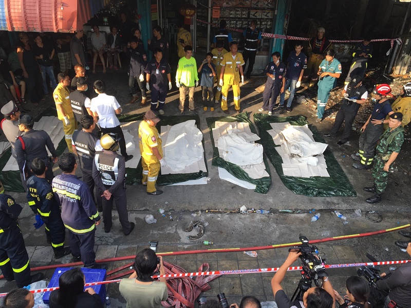 Police and rescue officials surround the bodies of five people killed early Wednesday morning in Bueng Kum, Bangkok.