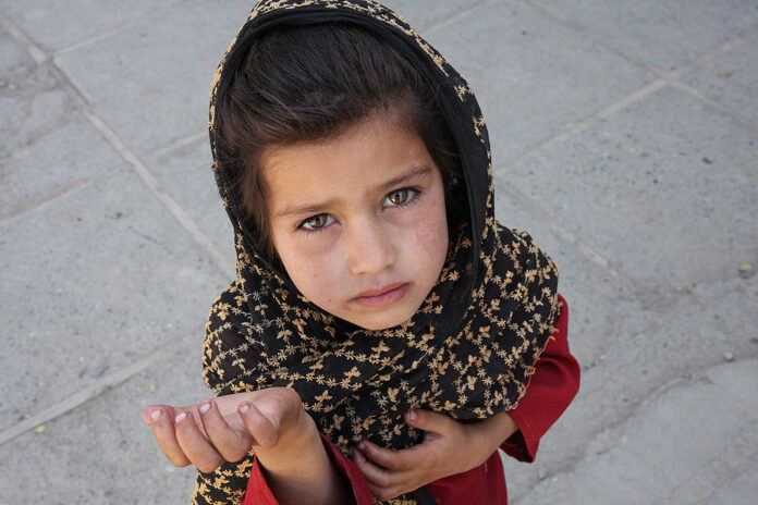 A young Afghan girl begging in the street in 2008 Kabul, Afghanistan. Photo: Mikhail Evstafiev / Wikimedia Commons