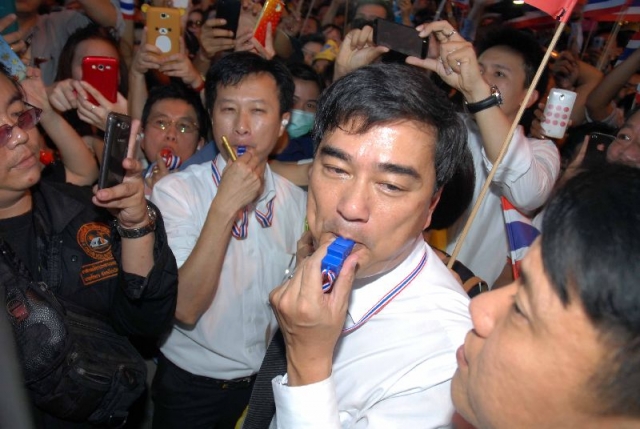 Democrat Party chairman Abhisit Vejjajiva blows a whistle on Nov. 4, 2013, in support of protesters opposed to a blanket amnesty. 