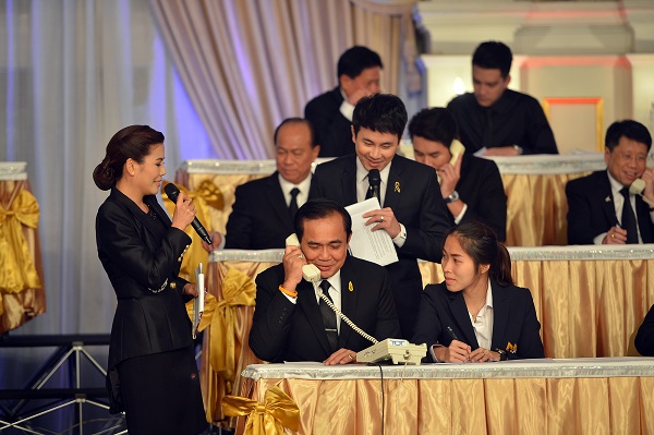 Prime Minister Prayuth Chan-ocha takes a call during a Sunday telethon to raise funds for the southern flood relief effort.