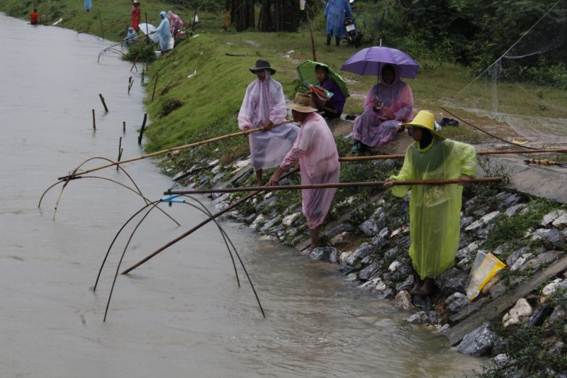 Residents fish in floodwaters Wednesday in Yala province.