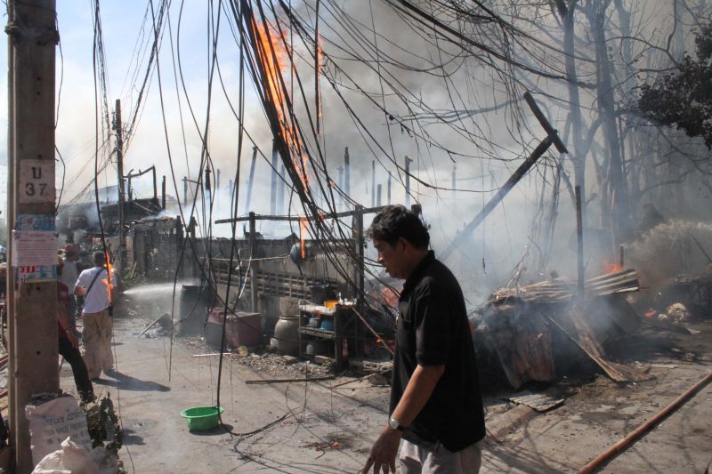 Burning wreckage after eight houses went up in flames in Bangkok’s Rat Burana district.