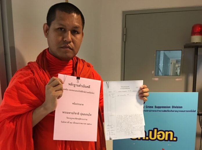 Phra Maha Aphichat Punnajantho shows his complaint on Wednesday at Technology Crime Suppression Division in Bangkok.