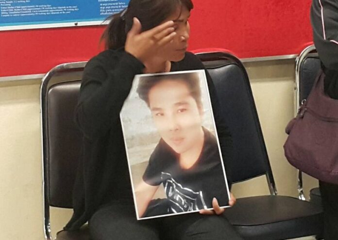 Mother of kidnap-murder victim Suphaksorn Pontaisong on Thursday wipes away tears as she waited to retrieve her daughter’s body at forensic police department.