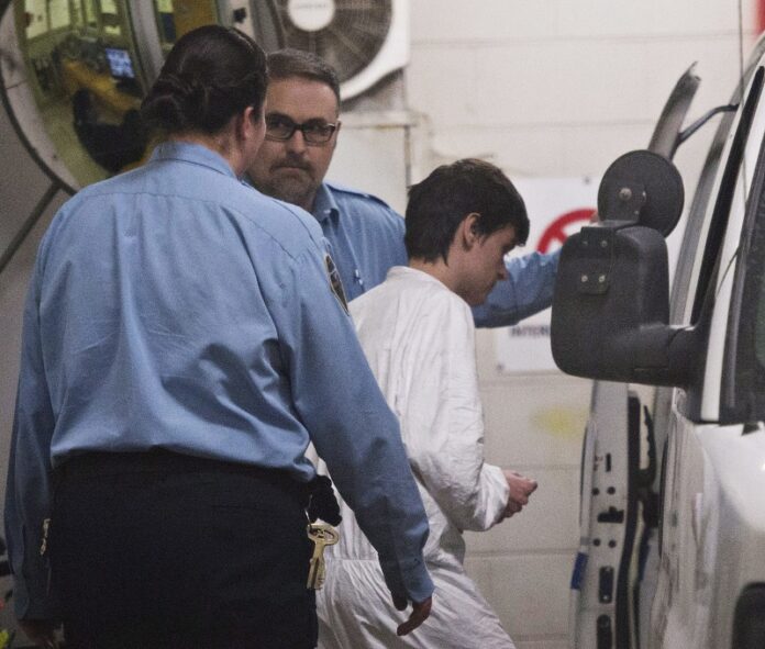 Alexandre Bissonnette is escorted to a van Monday in Quebec City, after appearing in court for Sunday's deadly shooting at a mosque. Photo: Jacques Boissinot / Associated Press